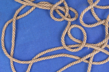 Ship rope on blue background, top view with copy space