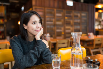 Woman thinking something in restaurant