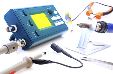 Modern digital signal oscilloscope and tools isolated on white background closeup