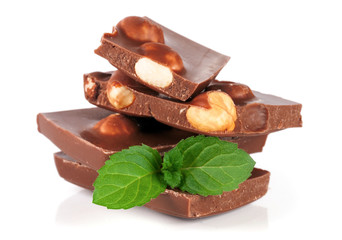 Chocolate with hazelnut and mint leaf isolated on white background