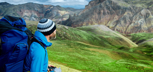 man hiker on the trail in the Islandic mountains. Trek in National Park Landmannalaugar, Iceland