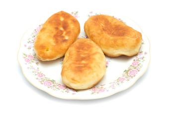 Obraz na płótnie Canvas Fresh baked russian pastry pirozhki isolated on white