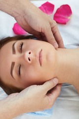 Woman enjoying a wellness neck massage in a spa. Health, beauty, resort and relaxation concept.