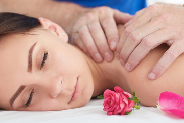 Obraz na płótnie Canvas Woman enjoying a wellness neck massage in a spa. Health, beauty, resort and relaxation concept.