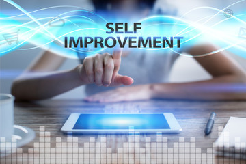 Woman using tablet pc, pressing on virtual screen and selecting self improvement.
