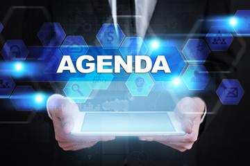 Businessman holding tablet PC with agenda concept.