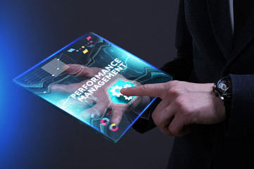 Business, Technology, Internet and network concept. Young businessman working on a virtual screen of the future and sees the inscription: Performance management
