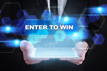 Businessman holding tablet PC with enter to win concept.