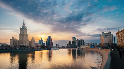 Wide panoramic view photography of evening city landscape with sun over the moscow river at sunset...
