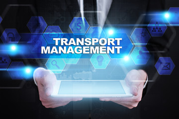 Businessman holding tablet PC with transport management concept.