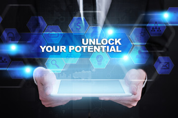 Businessman holding tablet PC with unlock your potential concept.