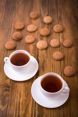 Tea and oaten cookies on a wooden table