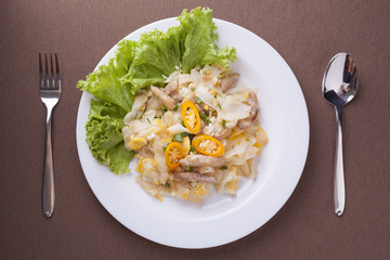 Fried noodle with chicken in white dish, delicious food for dinner.