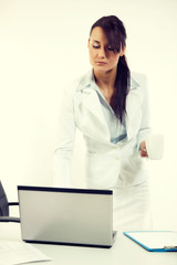 Young attractive business woman using laptop at the office