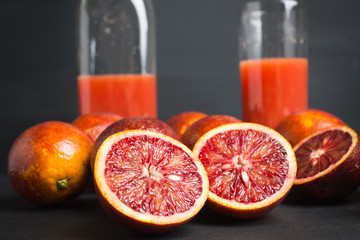 Red Sicilian oranges on the dark wooden background. Shallow depth of field.