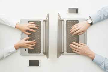 Naklejka na ściany i meble hands working for two laptops
