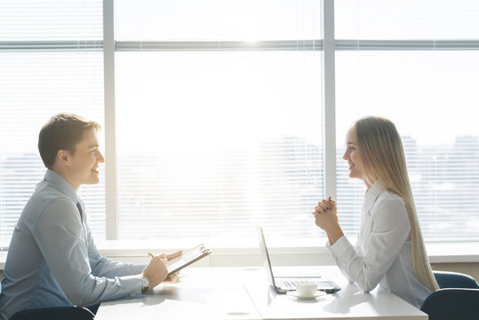 Outlines Of Two Businessmen Working Late In Office