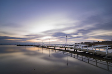 Fototapeta na wymiar wooden pier by the sea, long exposure, evening