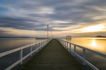 Obraz premium wooden pier by the sea, long exposure, evening