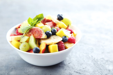 Fresh fruit salad on a grey wooden table