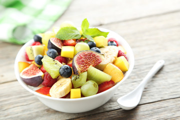 Fresh fruit salad on a grey wooden table