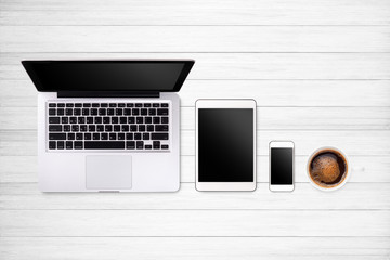 Laptop tablet smartphone  and coffee on wood table background with text space and copy space