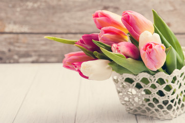 Bouquet of pink tulips in crochet basket