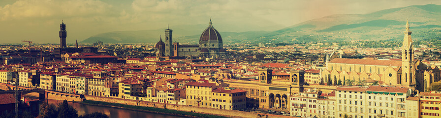 Fototapeta na wymiar Panoramic view of the beautiful medieval italian city and culture capital - Florence with cathedrals and bridges over river and cloudy sky. Travel outdoor sightseeing historical background.