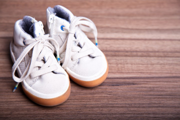 children's shoes  on wooden background with place for text. first shoes baby