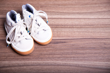 kid's brown  shoes on wooden background