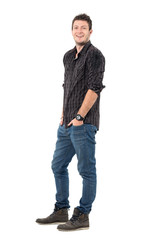 Relaxed happy laughing young man wearing jeans and plaid shirt. Full body length portrait isolated over white studio background. 