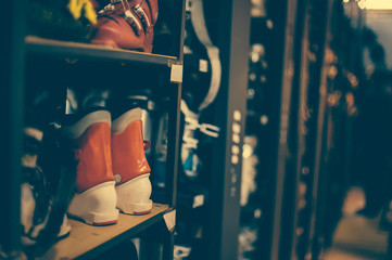 Ski and snowboard boots exposed in the rental winter shop