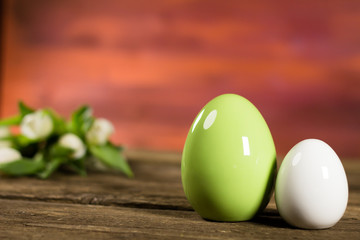 Easter theme eggs with tulips on wooden board, easter holiday concept. Copyspace for text.