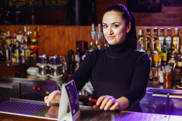 Girl bartender at the bar