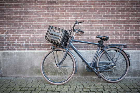 bike with plastic crate against the wall