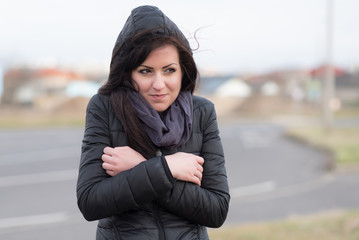 Brown woman feeling cold on the street