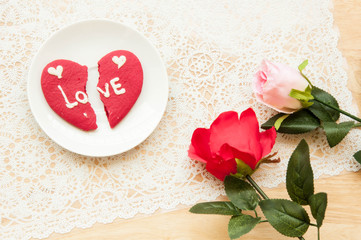broken heart cookie of love and plastic rose