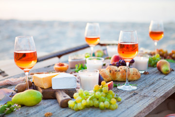 Picnic on the beach at sunset in boho style, food and drink concept - 141237614