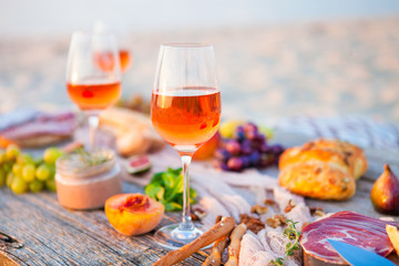 Picnic on the beach at sunset in boho style, food and drink concept - 141237620