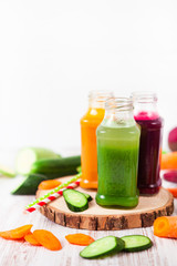 Freshly squeezed vegetable juice in bottles, useful vitamin cocktail, detox diet, selective focus