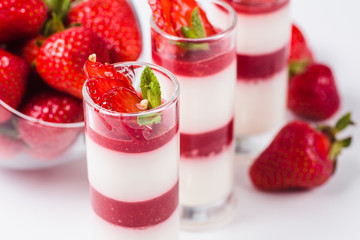 Strawberry Panna Cotta on a white background (close)