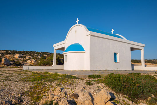 Small church on the rocky shore of the cape Greco. Close up