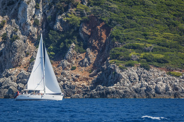 Sailing boat close to rocks