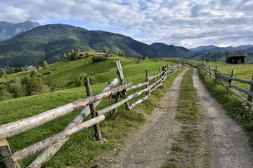 Fototapeta na wymiar September rural scene in Carpathian mountains. Authentic village and fence