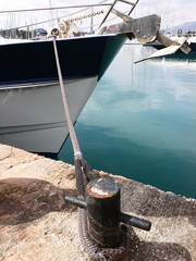 Bateau à moteur à voile dans la marina amarré sur bollard