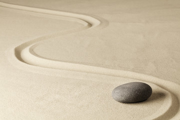 Fototapeta na wymiar Japanese zen garden stone with line in sand. Balance and harmony for relaxation and meditation. Spa wellness background...
