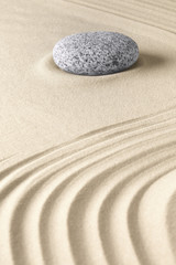 zen meditation stone and sand pattern.