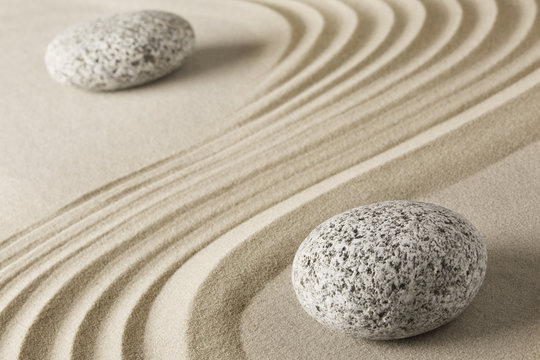 Yin and yang  Chinese Tao philosophy. Stones and sand pattern. Round rocks stand for Ying and jang in zen stone garden.