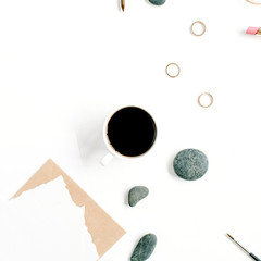 Top view office table desk. Workspace with coffee, craft envelope, stones, female accessories and paper blank on white background. Flat lay.