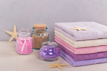 Stack of colorful bath towels on light background.